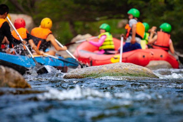Close-up of reef with group of young people are rafting on the river, at tourist attraction in Armenia
