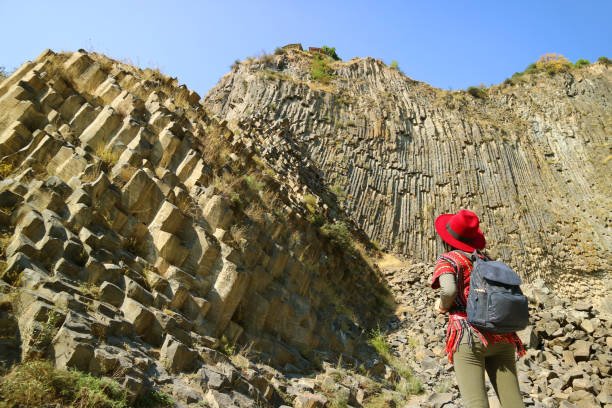 Woman Impressed by the Incredible Symphony of Stones Basalt Column Formations Along the Garni Gorge, Armenia