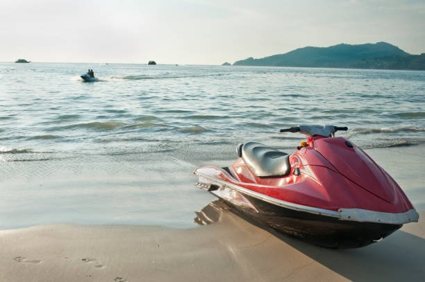 Red jet ski on the beach at the water's edge in sevan lake