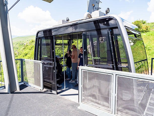 Halidzor, Armenia - May 25, 2025: visitors in funicular car of Wings of Tatev aerial tramway at station in Halidzor village in Syunik Province of Armenia on sunny May day