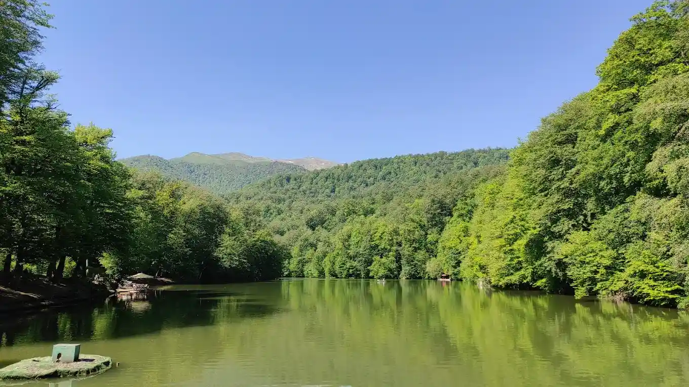 Parz Lake reflecting the green forest and sky in Dilijan