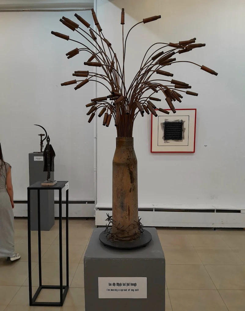 An artist discussing their work during an exhibition at the Artists Union.