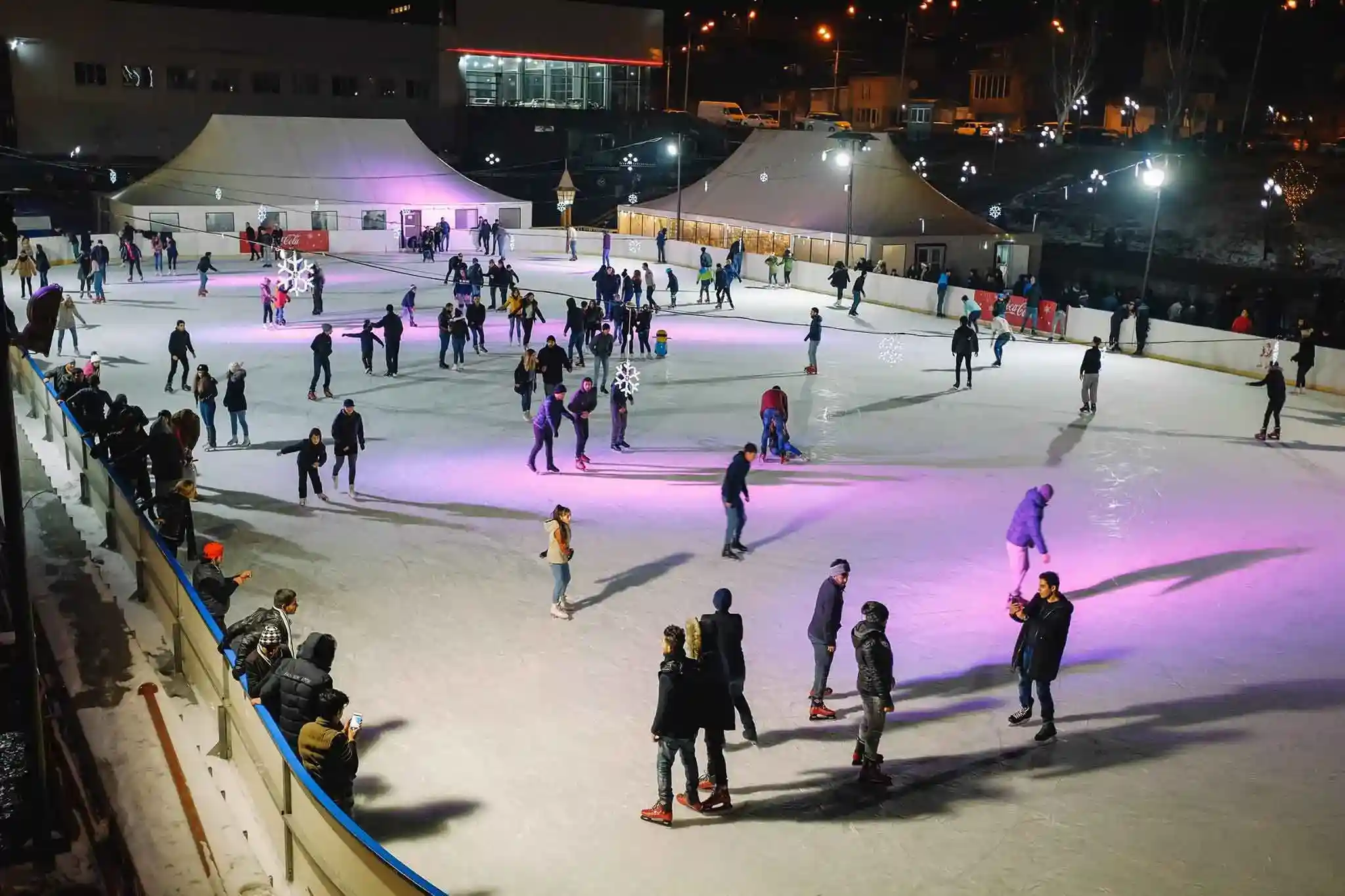 Children playing at Winter Park Yerevan with lights and decorations