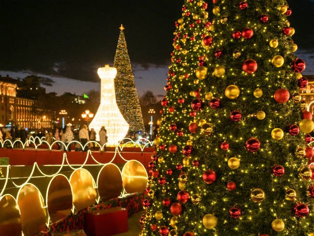 decorated Xmas trees on Republic Square in Yerevan city in winter evening