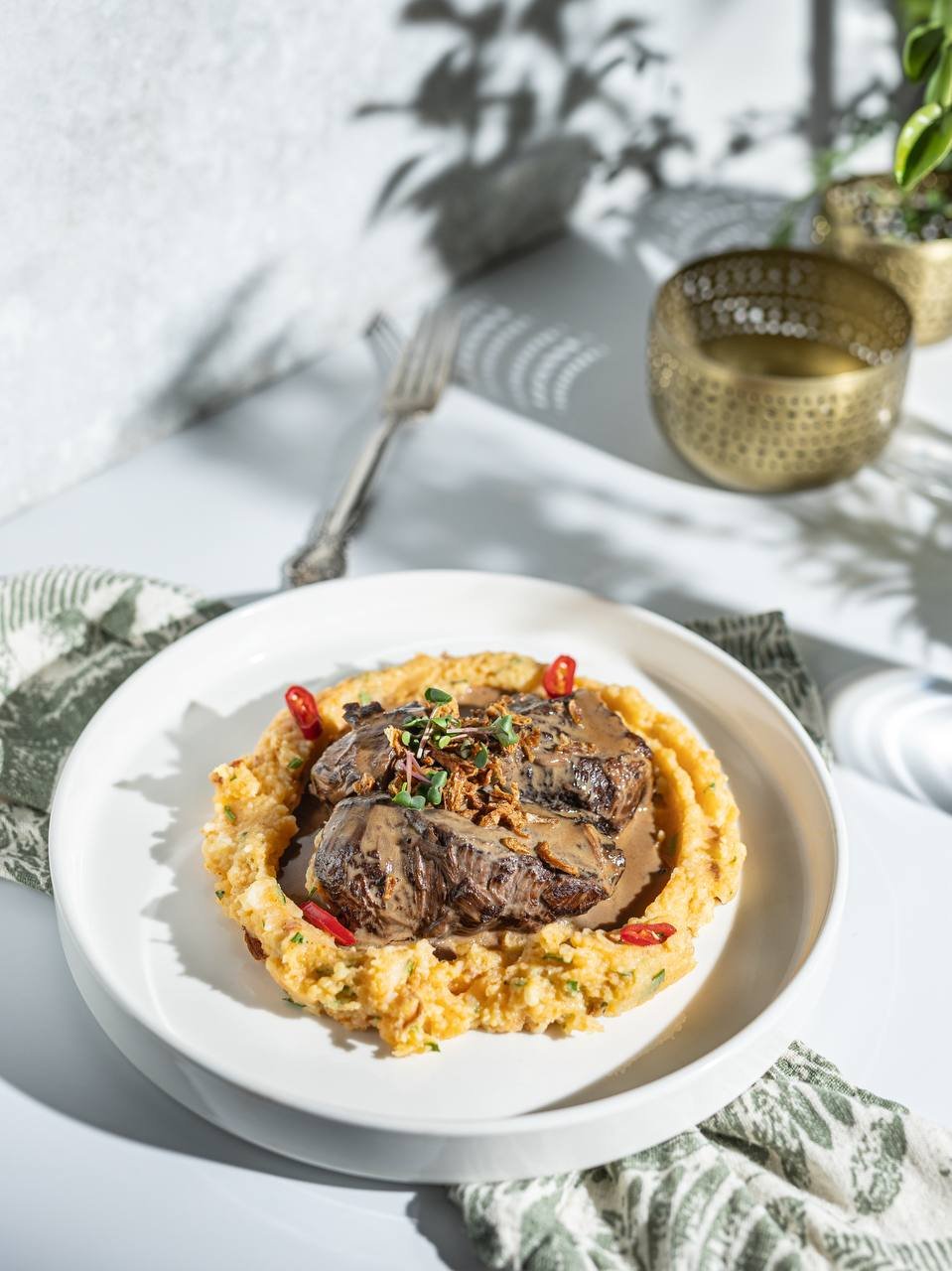 stewed beef with mashed potatoes and fried onions